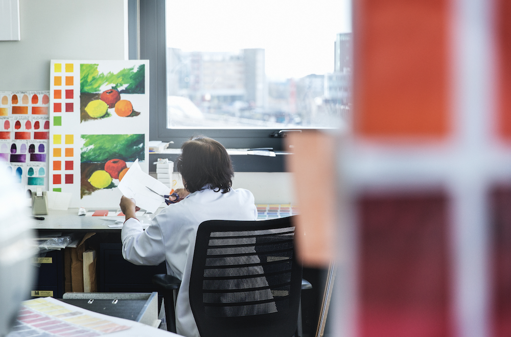 Scientist analyzing colour chart at Winsor & Newton head office lab, London